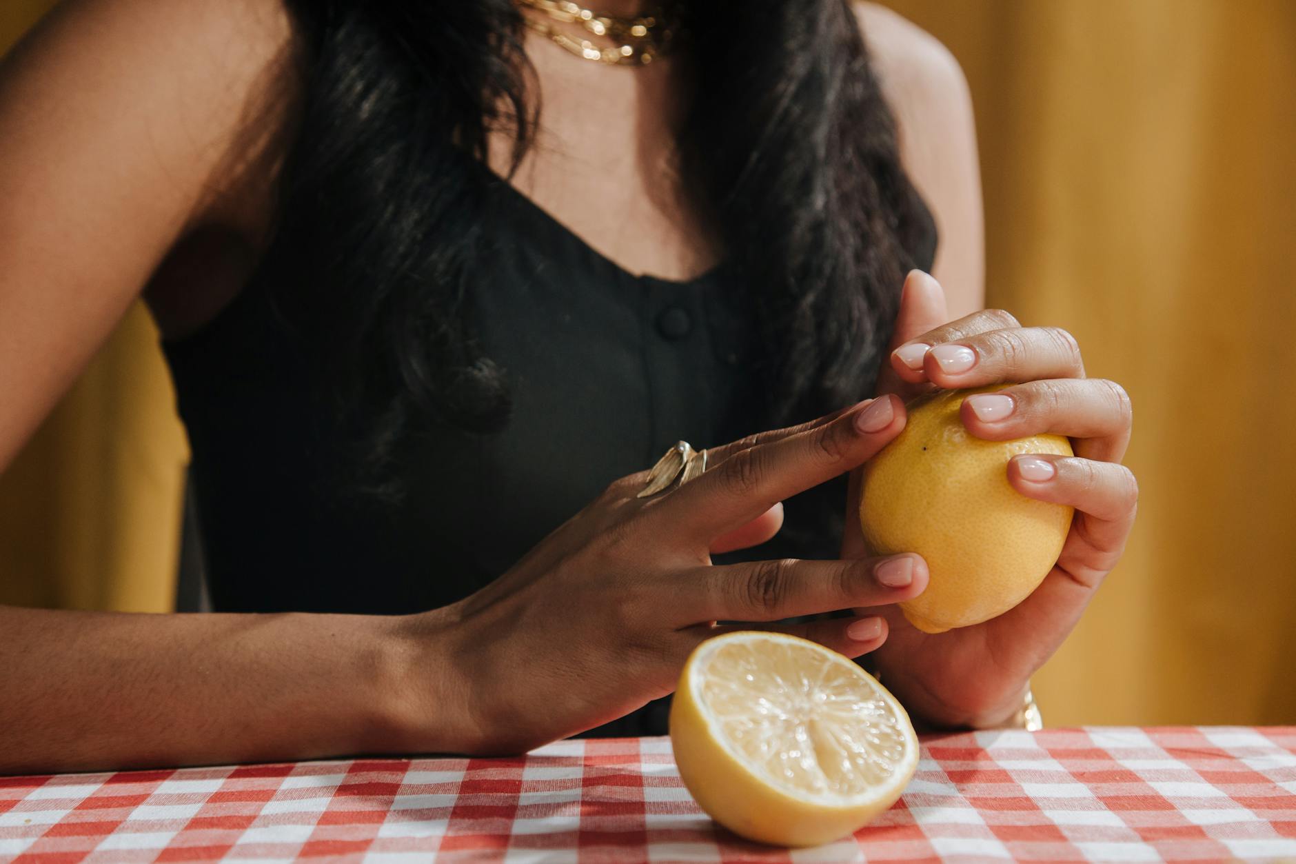 Fresh lemons arranged on a bright yellow background, symbolizing the citrus-inspired design of lemon vibrators