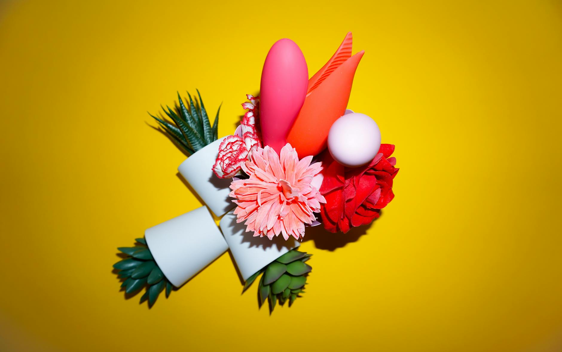 Hands holding pastel-colored silicone toys for comfortable exploration