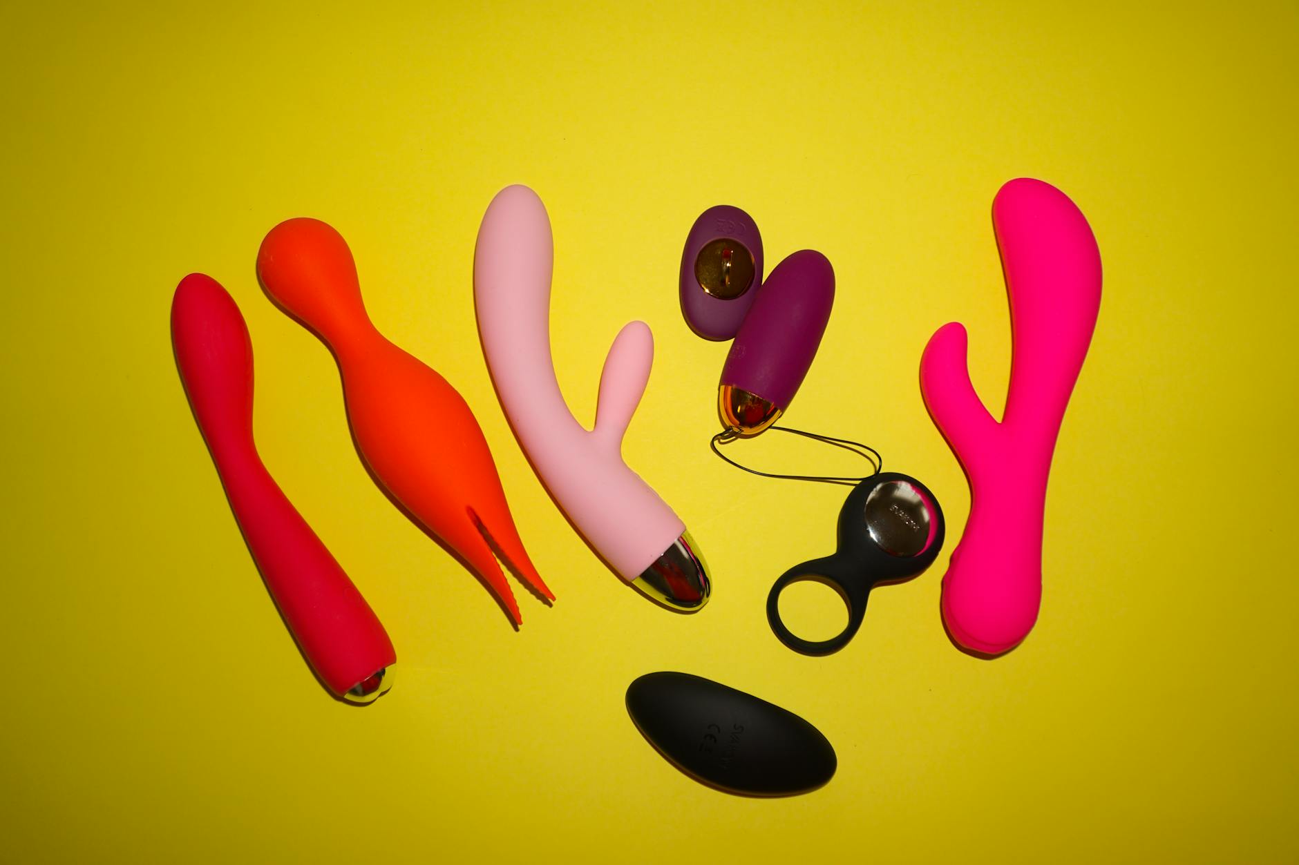 Hands holding a lemon clitoral vibrator against a soft knitted surface